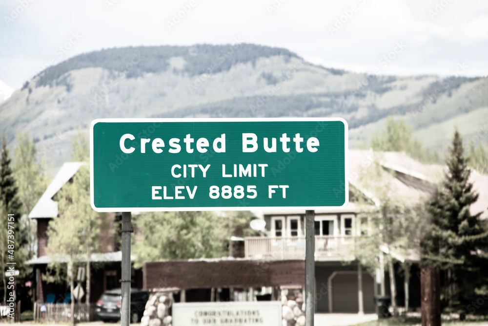 Crested Butte sign with buildings and town in background at Colorado USA ski resort in summer