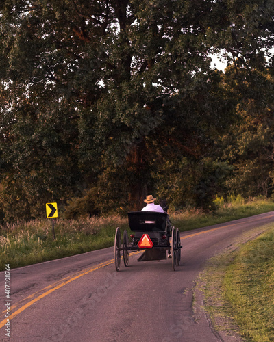 Amish Man Riding a Horse and Buggy on a Small Country Road   Holmes County, Ohio © Isaac