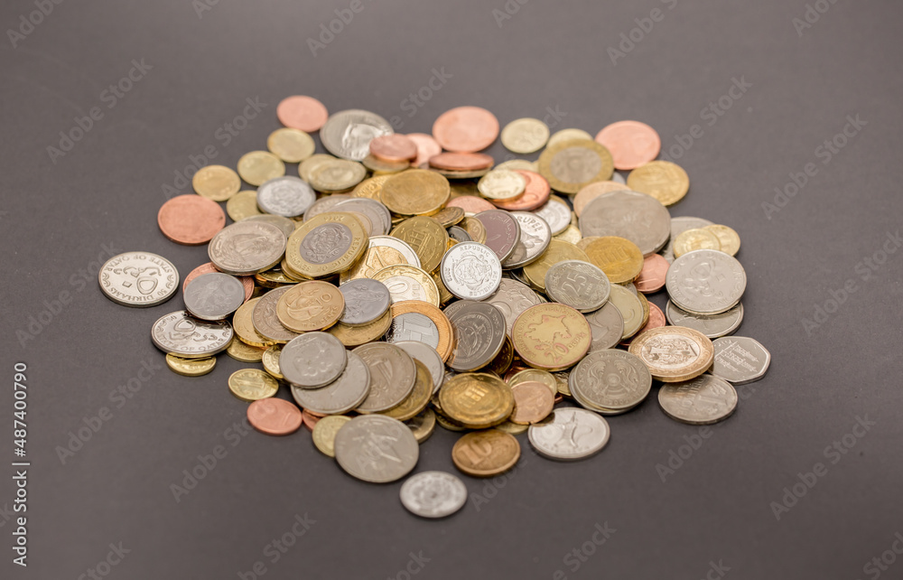 Different money coins. US dollars money and euro as a background on a flat lay. Savings and economy. Coins of different denominations from different countries. Inflation and exchange rates. Different money coins. US dollars money and euro as a background on a flat lay. Savings and economy. Coins of different denominations from different countries. Inflation and exchange rates.