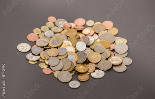 Different money coins. US dollars money and euro as a background on a flat lay. Savings and economy. Coins of different denominations from different countries. Inflation and exchange rates.
