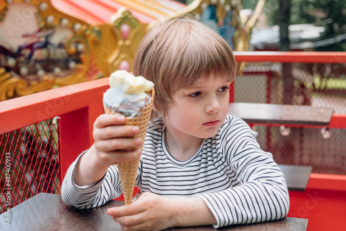 Kid enjoys ice-cream in the park