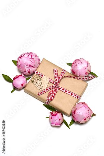 gift box, pink peonies, wooden heart on a white background