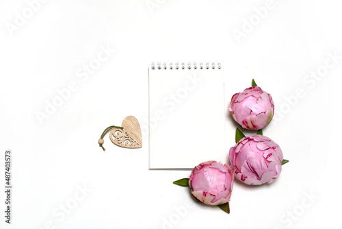 sheet for writing, pink peonies, wooden heart on a white background