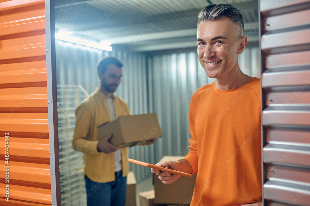 Storehouse workers unloading cargo in the container