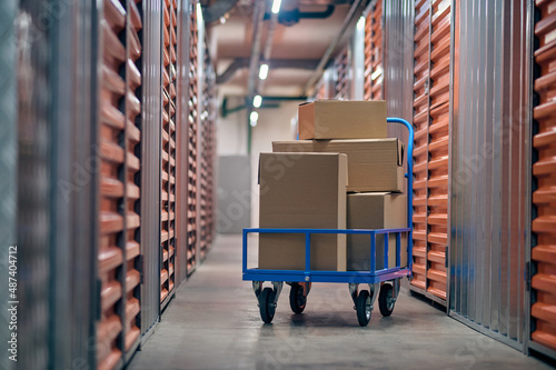 Stacked boxed goods lying on the hand truck