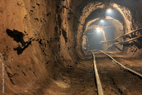 Narrow gauge railroad in the underground mine horizon. Technologies of mining of minerals by the underground method. Underground mine for mining ore
