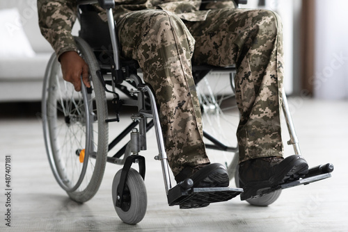 Foto Legs of disabled african american military man in wheelchair