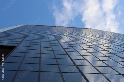 Genova, Italy - January 29, 2022: Beautiful modern high-rise buildings against the sky. 3d illustration on the theme of business success and technology. clouds reflection on the mirror.