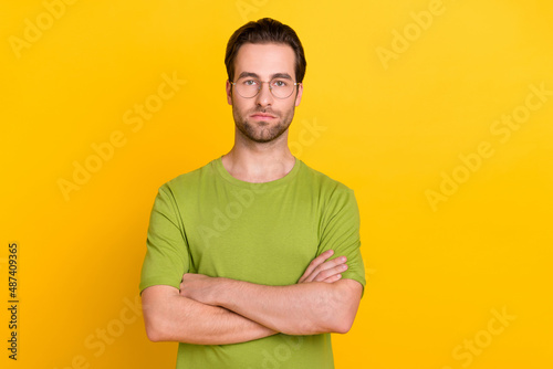 Photo of boss beard millennial guy crossed arms wear spectacles green t-shirt isolated on yellow color background