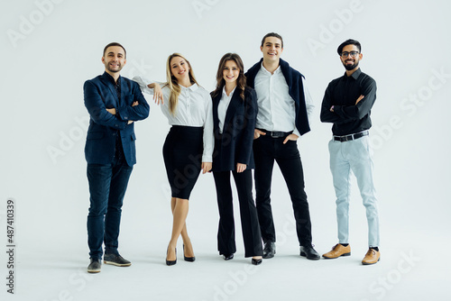 Happy business team smiling isolated over a white background