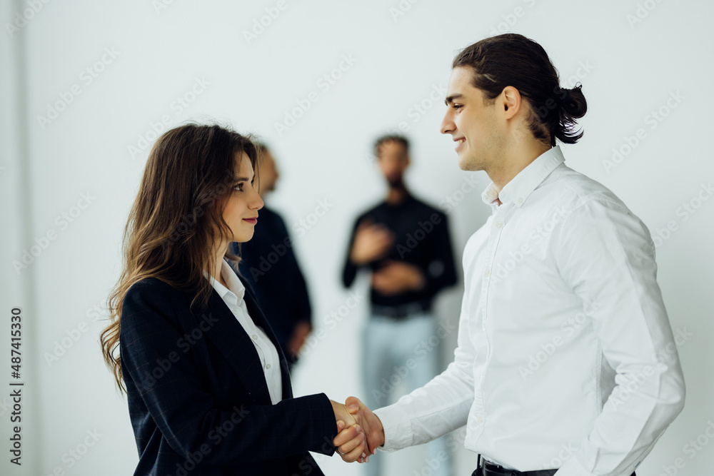 Business people shaking hands, finishing up a meeting in office Business people shaking hands, finishing up a meeting in office