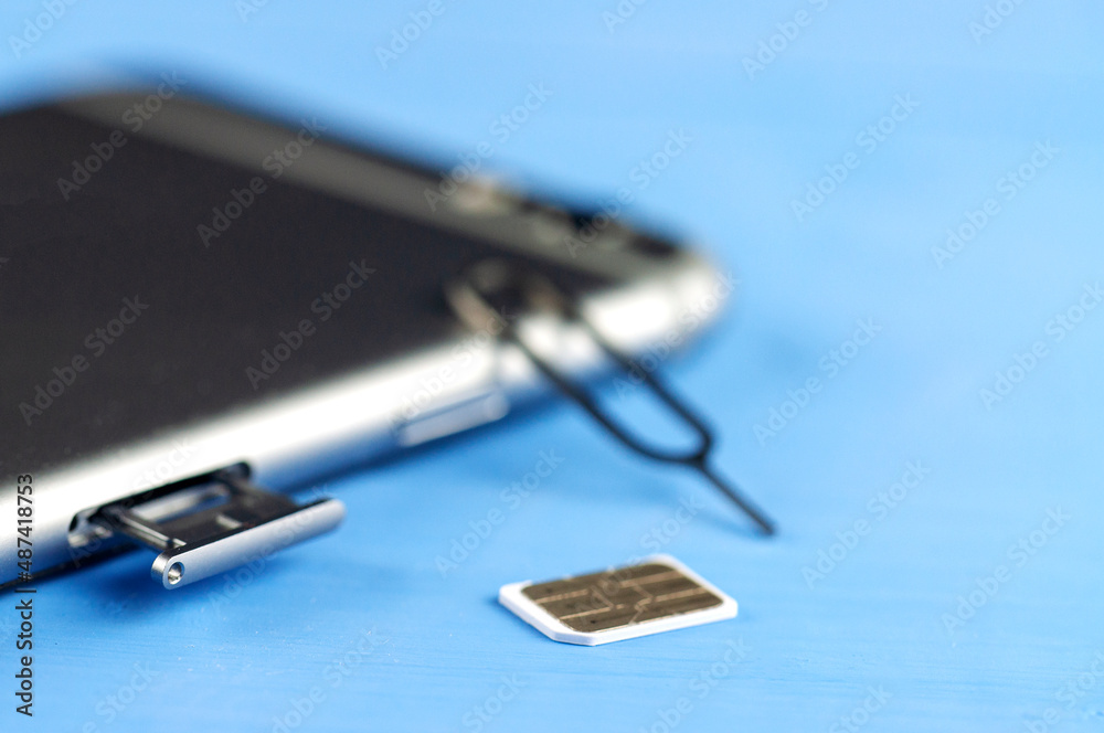 smartphone with a SIM card key, SIM card, SIM card space is open. smartphone with a SIM card key, SIM card, SIM card space is open.