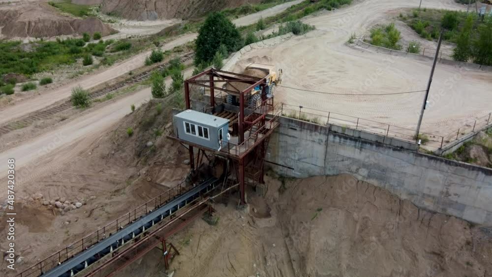 Aerial showing giant truck dumping sand in sorting machine in quarry. Aerial showing giant truck dumping sand in sorting machine in quarry.