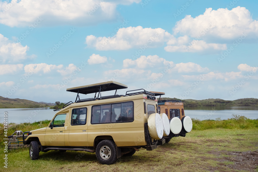  Arusha, Tanzania, 31 january 2022.  two safari jeeps 4x4 with open roofs stand near the lake in the African park Tarangire - obrazy, fototapety, plakaty 