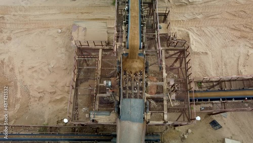 Aerial top-down view of sorting net and conveyour belts with sand and rocks. photo