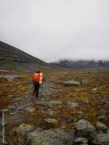 Hiker woman walking in a mountain rocky path