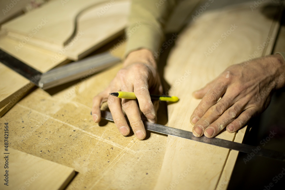 Guy marks board on ruler. Marking with pencil. Carpenter measures surface. Guy marks board on ruler. Marking with pencil. Carpenter measures surface.