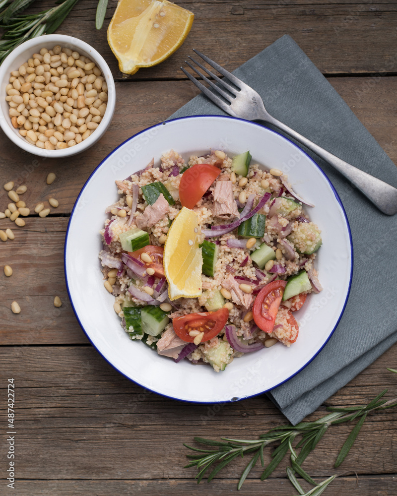 Food dieting concept, tuna salad. Couscous salad with conserved tuna, tomatoes, cucumbers and purple onions on table. Copy space. Food dieting concept, tuna salad. Couscous salad with conserved tuna, tomatoes, cucumbers and purple onions on table. Copy space.