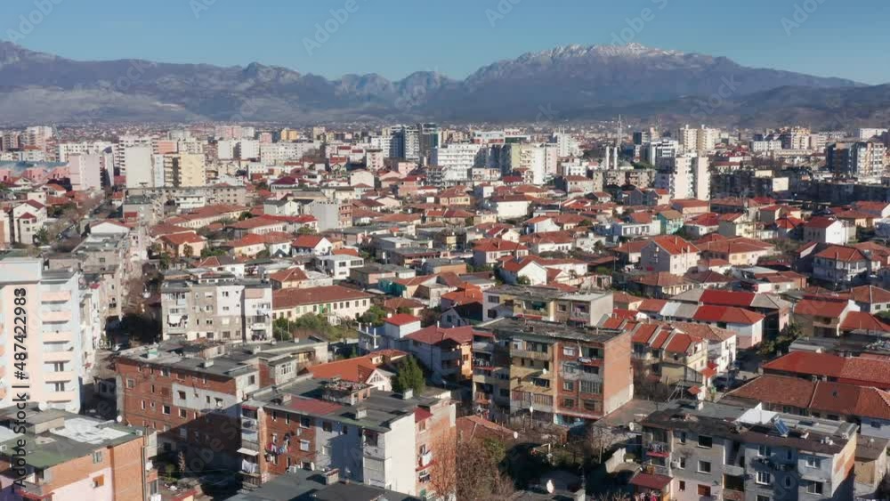Shkoder Albania cityscape - skyline of a city, with buildings and houses, surrounded by high hills and mountains. Aerial drone view of Shkodra (Skadar) on a sunny day with clear blue sky. Shkoder Albania cityscape - skyline of a city, with buildings and houses, surrounded by high hills and mountains. Aerial drone view of Shkodra (Skadar) on a sunny day with clear blue sky.