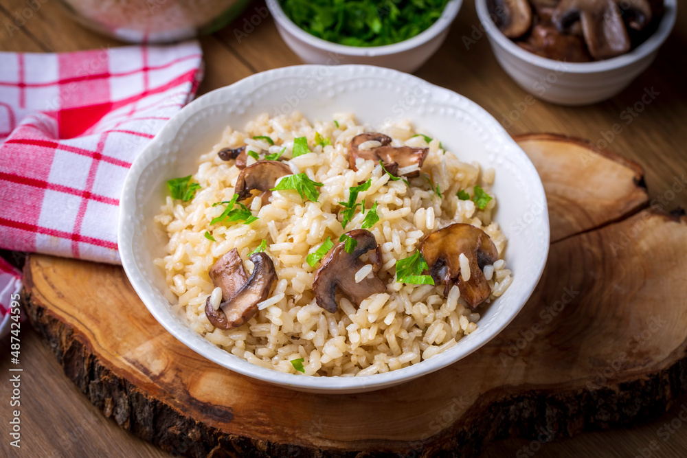 Mussel rice pilaf. Rice with mussels on small white plate on ceramic. Mussel rice pilaf. Rice with mussels on small white plate on ceramic.