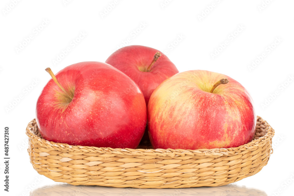 Three sweet organic, red apples in a plate of straw, macro, isolated on a white background.
Three sweet organic, red apples in a plate of straw, macro, isolated on a white background.