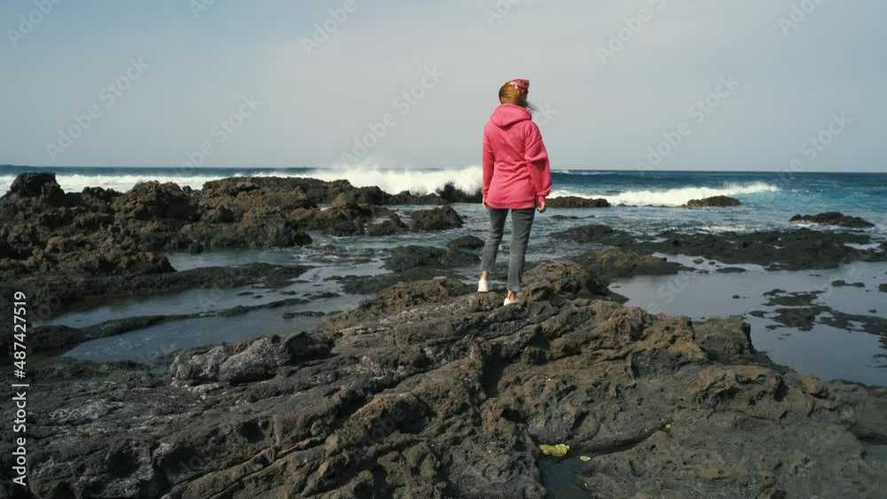 woman enjoying the ocean on volcanic beach of the Canary island of Tenerife. Beautiful landscapes in the north of Tenerife island
woman enjoying the ocean on volcanic beach of the Canary island of Tenerife. Beautiful landscapes in the north of Tenerife island