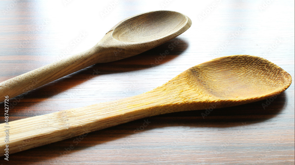 Spoons. Wooden spoons on the wooden table under window light. Spoons. Wooden spoons on the wooden table under window light.
