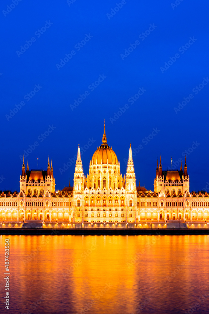 Detail of the illuminated parliament building in Budapest, Hungary, in the evening - Parliament in Budapest illuminated at dusk