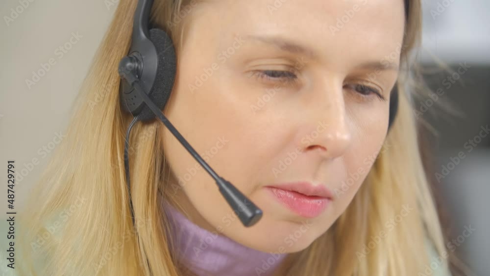 Call center operator woman in headset talking to client. Video portrait of online it support specialist speaking with customer online. Freelancer female wearing headphone with microphone Call center operator woman in headset talking to client. Video portrait of online it support specialist speaking with customer online. Freelancer female wearing headphone with microphone