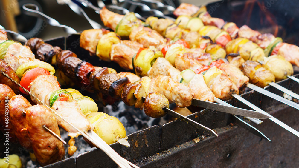 Delicious bbq grilled meat and vegetables on barbecue grill outdoors.