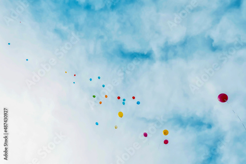 balloons flying in the sky among the clouds. Festive background