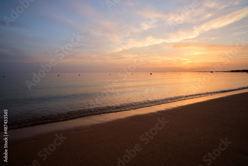 Wallpaper Mural Calm sea shore with crushing waves on sandy beach at sunrise Torontodigital.ca