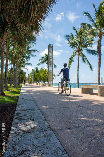 A summer afternoon and fun riding a bike in a park in by front Miami