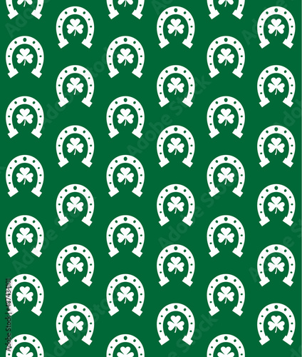 Vector seamless pattern of flat horse shoe with trefoil isolated on green background