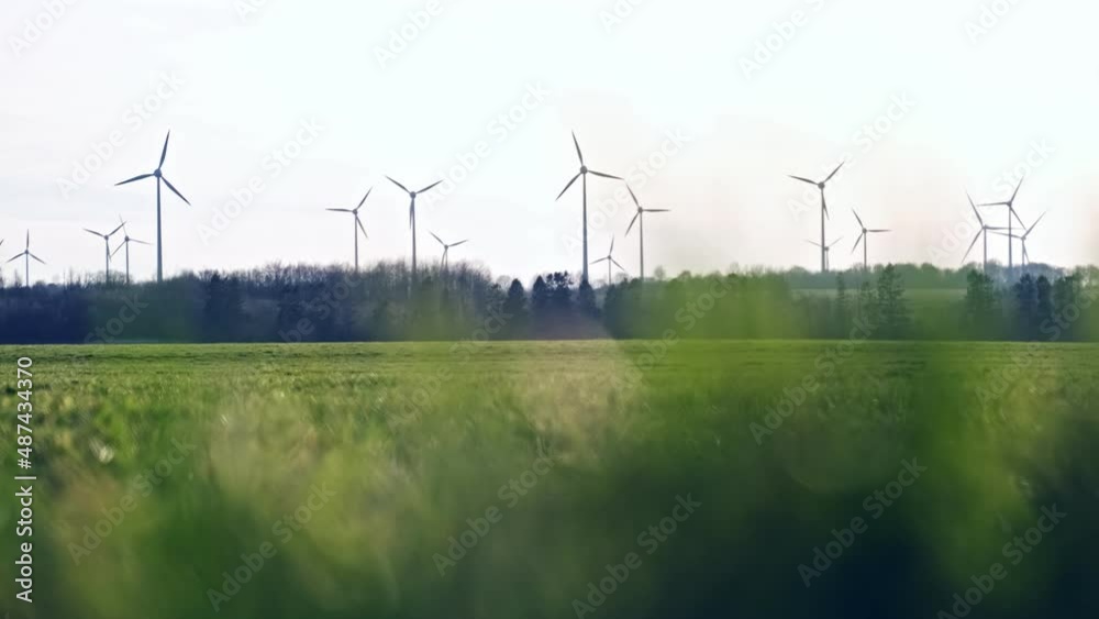 Open Field Horizon with Wind Power Plant Farm with Tall Turbines Rotating during Beautiful Windy Day Open Field Horizon with Wind Power Plant Farm with Tall Turbines Rotating during Beautiful Windy Day