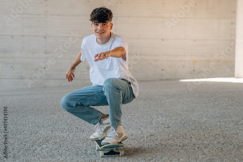 millennial teenager with skateboard in the street
