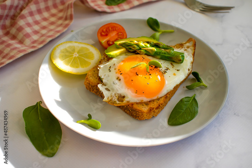 sandwich with egg, avocado, asparagus on old background