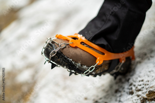 Close up of snow shoes and shoe spikes in winter.  photo
