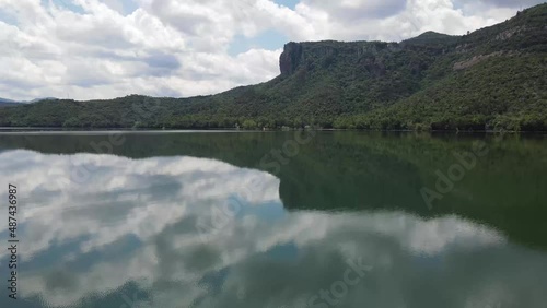 Dron shot Espania Spain open shot sun afternoon sky buildings smog water lake paning left moutan sea covid trees tree front green blue back cars rush hour road covid empty sun sunset natura lake.mp4