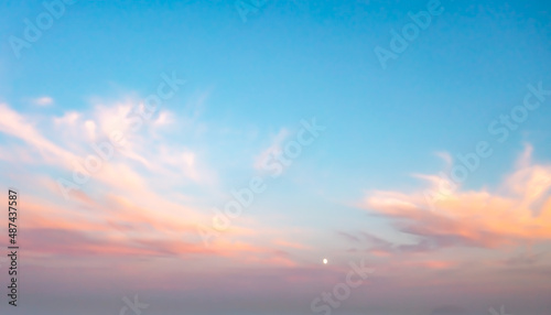 A beautiful sky painted by the sun leaving vibrant gold and pink hues. Clouds in the twilight sky in the evening. Image of a cloudy sky in the evening. Evening sky scene with golden light 