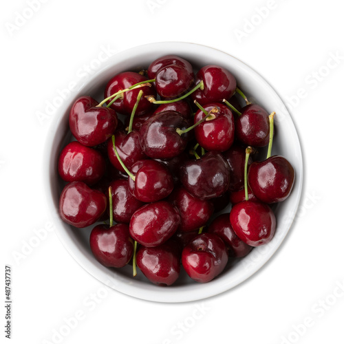 Red cherries on a bowl isolated over white background