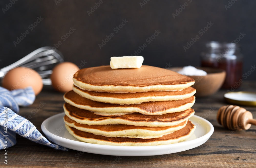 Blini or pancakes stack on wooden table with butter. Maslenitsa holiday concept. Rustic style breakfast Blini or pancakes stack on wooden table with butter. Maslenitsa holiday concept. Rustic style breakfast