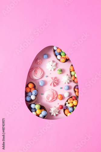 Photography Chocolate easter eggs and decor flat lay for kids easter hunt egg concept on pink background