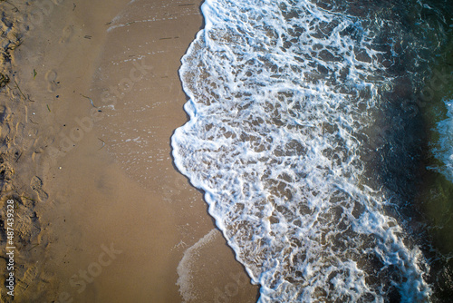 the waves of the sea wash up on a beach