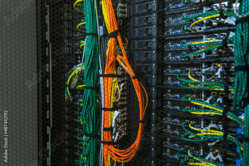 Server internet datacenter room, network. Fiber connectivity. Data center. Color cables installed in the rack. Array disk storage in data center. photo