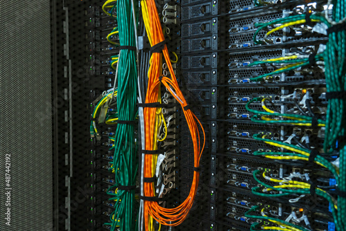 Server internet datacenter room, network. Fiber connectivity. Data center. Color cables installed in the rack. Array disk storage in data center.
