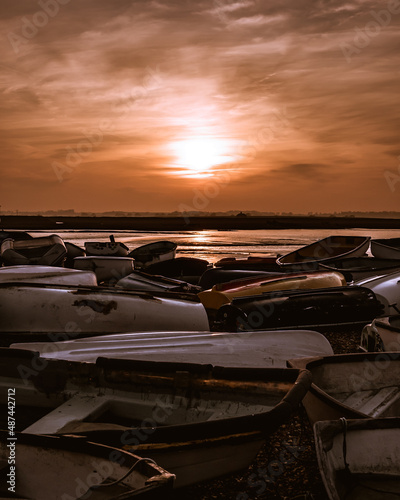 Overturned boats in front of summer sunset at Felixstowe Ferry