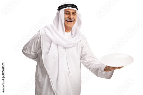 Tablou canvas Mature arab man holding an empty plate and smiling