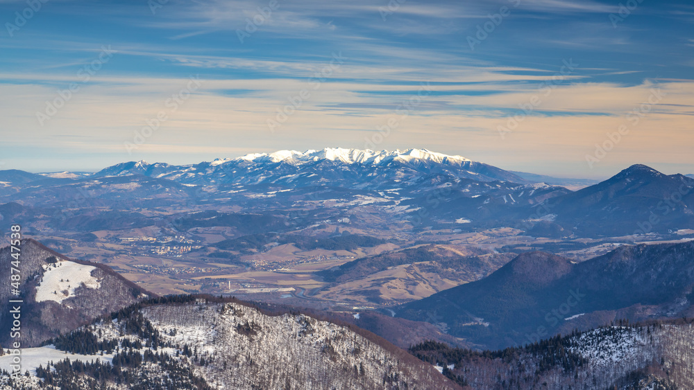 View of the winter landscape with snowy mountains of Western Tatras National Park on background, Slovakia, Europe.