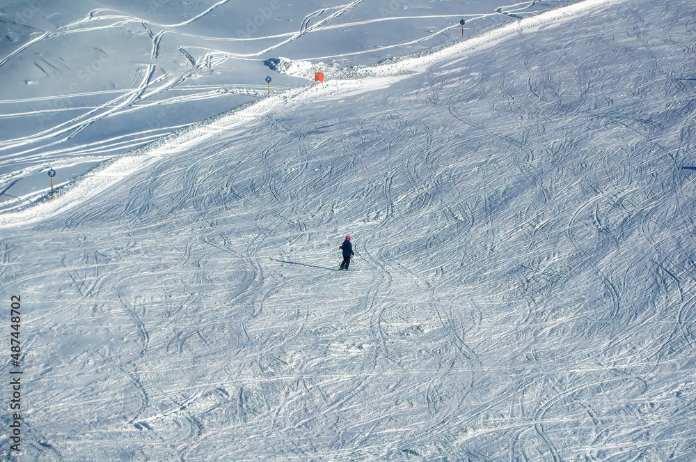 Skiers at ski slope during sunny winter day in Soelden, Austria.